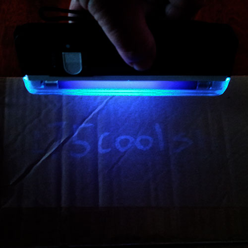 A black light showing up a hidden message on a box