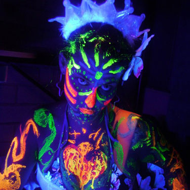 A guest at a UV Paint Party with UV Face Body Paint on her